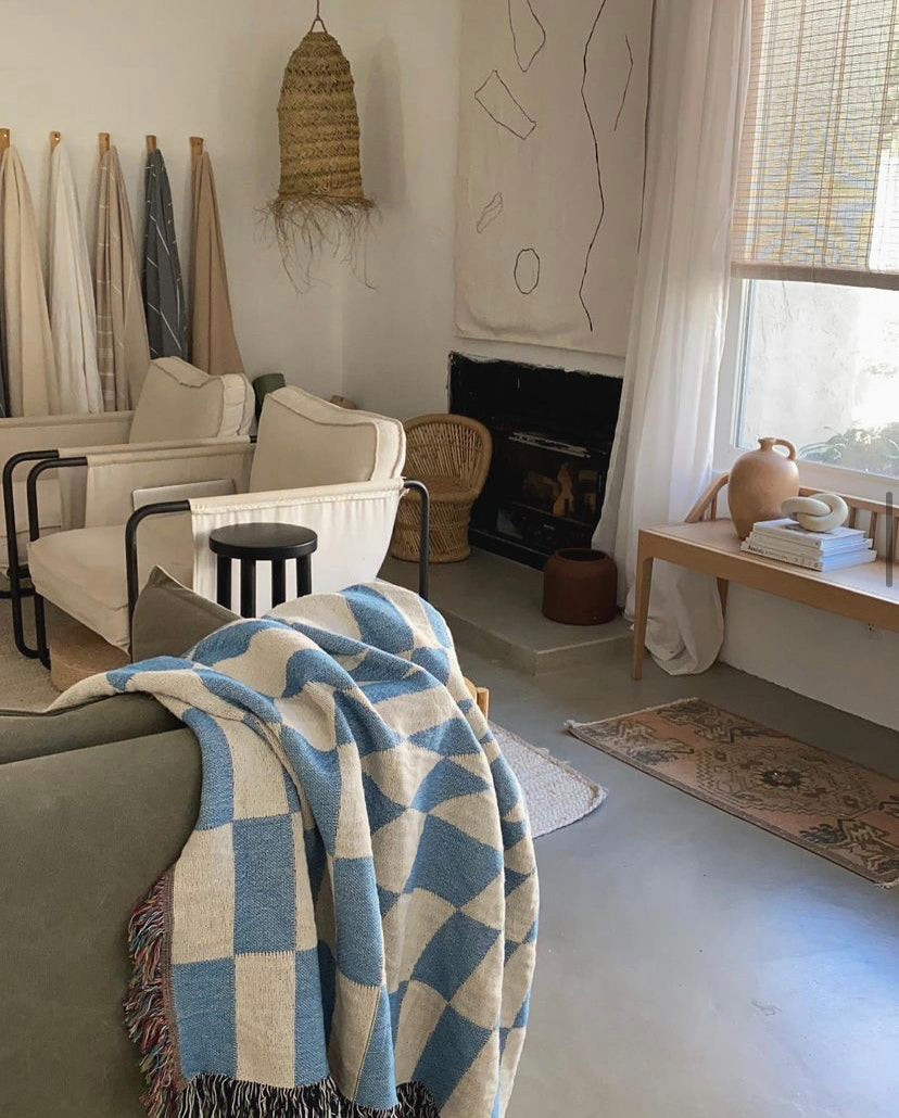 Groovy Grid sky blue on a couch in a chic living room.