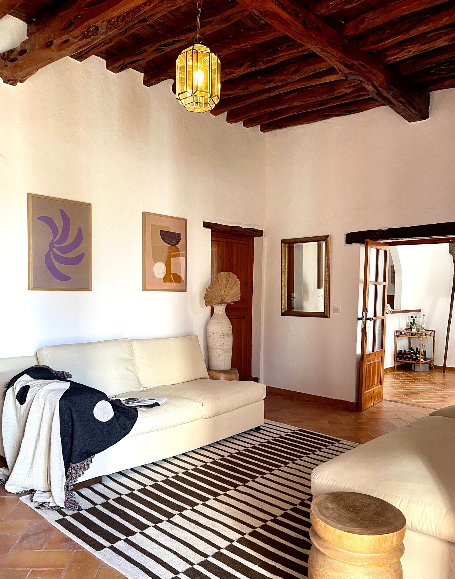 A spacious and exotic living room featuring the clr shop yin yang woven throw.